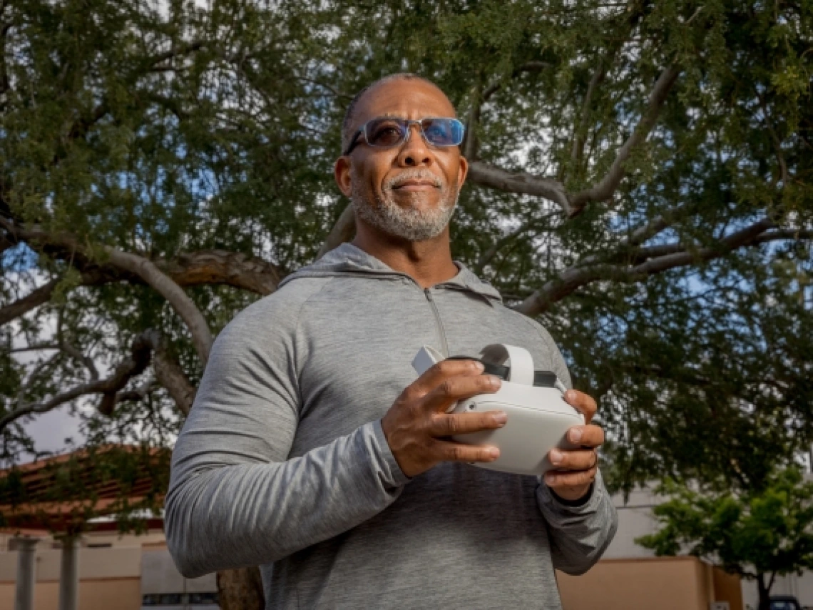 Bryan Carter holds a virtual reality headset